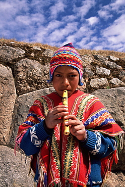 Peruvian boy playing the flute, Peru, South America