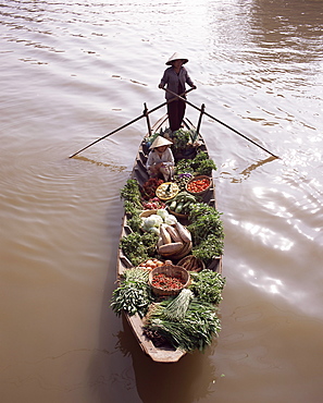 Floating market trader and boat laden with vegetables, Phung Hiep, Mekong River delta, Vietnam, Indochina, Southeast Asia, Asia