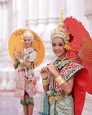 Portrait of two dancers in traditional Thai classical dance costume, smiling and looking at the camera, Bangkok, Thailand, Southeast Asia, Asia