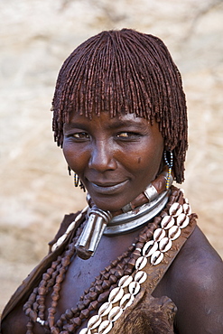 Portrait of a woman of the Hamer tribe, her hair treated with ochre, water and resin and twisted into tresses known as goscha, Lower Omo Valley, Southern Ethiopia, Africa