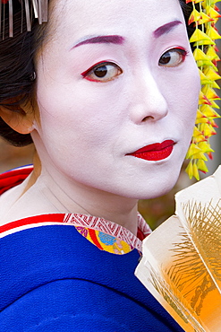 Portrait of a geisha holding a traditional paper fan, Kyoto, Kansai region, Honshu, Japan, Asia