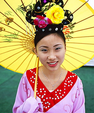 Portrait of a young woman holding parasol, smiling,Yangtze River, Chongqing, Chongqing City, Sichuan Province, China, Asia