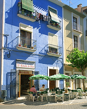 Pavement cafe in front of a blue painted building in Villajoyosa, Valencia, Spain, Europe