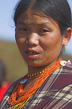 Naga (Macham tribe) lady with face tattoos (said to be done when they are children so that they are not attractive to men who may steal them away from their village), Magyan Village, Sagaing Division, Myanmar (Burma), Asia