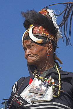 The Naga  (Macham tribe) chief of the village wearing traditional hat made of woven cane decorated with wild boars teeth and bear fur, also bead necklace with tiger teeth, Magyan Village, Sagaing Division, Myanmar (Burma), Asia