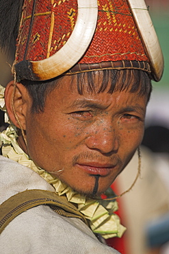 Naga man wearing headdress made of woven cane decorated with wild boar teeth and bear fur, Naga New Year Festival, Lahe village, Sagaing Division, Myanmar (Burma), Asia