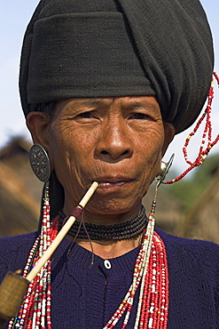 Wan Sai village (Aku tribe), Aku lady smoking wooden pipe, Kengtung (Kyaing Tong), Shan State, Myanmar (Burma), Asia