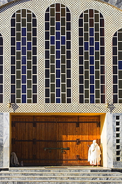 Pilgrim at doors of St. Mary of Zion new church, built by Haile Selassie in the 1960s, Axum, Ethiopia, Africa