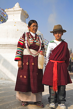 Tibetan mother and son in traditional clothes at Lhosar (Tibetan and Sherpa New Year) festival, Bodhnath stupa, UNESCO World Heritage Site, Bagmati, Kathmandu, Nepal, Asia