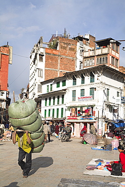 Man carrying heavy load through the street, Hanuman Dhoka, Durbar Square, UNESCO World Heritage Site, Kathmandu, Nepal, Asia