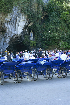 Pilgrims at grotto, Lourdes, Midi Pyrenees, France, Europe