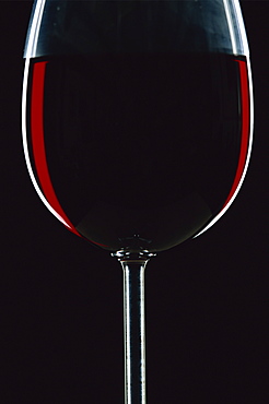 Backlit shot of a glass of red wine