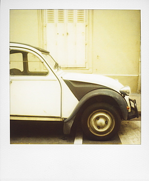 Polaroid of old black and white Citroen 2CV parked on street, Paris, France, Europe