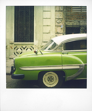 Polaroid of profile of green classic American car parked on street, Vinales, Cuba, West Indies, Central America