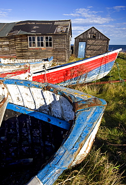 Old fishing boats and delapidated fishermens huts, Beadnell, Northumberland, England, United Kingdom, Europe