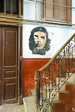 Faded mural of Che Guevara on the staircase of a dilapidated apartment building, Havana Centro, Havana, Cuba, West Indies, Central America