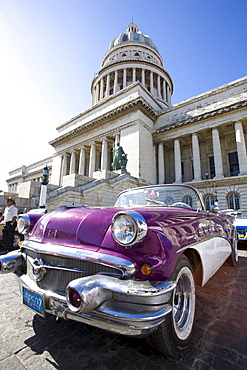 Restored classic American car parked outside The Capitilio, Havana, Cuba, West Indies, Central America