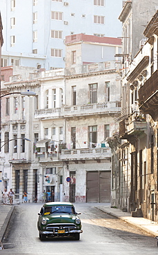 Classic American car taxi driving down quiet street in Havana Centro, Havana, Cuba, West Indies, Central America