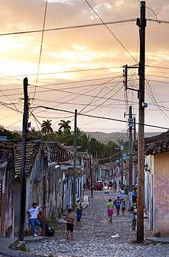 View along traditional cobbled street at sunset, Trinidad, Cuba, West Indies, Central America