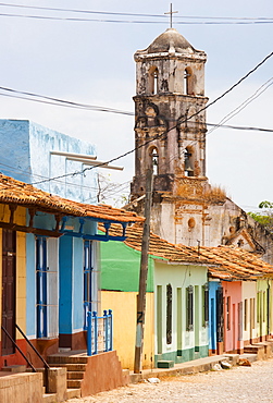 Street scene showing houses painted in bright colours and the ruins of an old church, Trinidad, UNESCO World Heritage Site, Cuba, West Indies, Central America