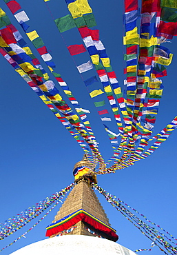 Bodhnath Stupa (Boudhanth) (Boudha), one of the holiest Buddhist sites in Kathmandu, UNESCO World Heritage Site, with colourful prayer flags against clear blue sky, Kathmandu, Nepal, Asia