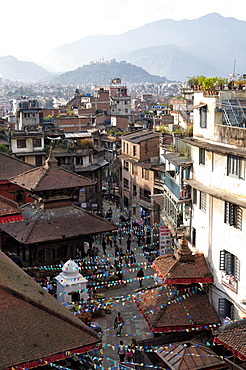 View over narrow streets and rooftops near Durbar Square towards the hilltop temple of Swayambhunath, Kathmandu, Nepal, Asia