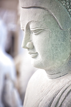 Marble Buddha images waiting to be finished at a stone carver's in Amarapura, near Mandalay, Myanmar (Burma), Southeast Asia