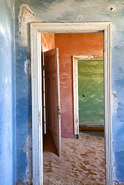 Interior of building slowly being consumed by the sands of the Namib Desert in the abandoned former German diamond mining town of Kolmanskop, Forbidden Diamond Area near Luderitz, Namibia, Africa 