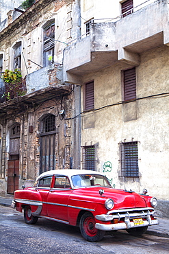 Red vintage American car parked on a street in Havana Centro, Havana, Cuba, West Indies, Central America