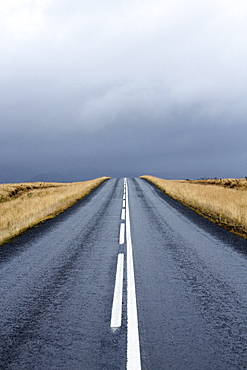 Road stretching away towards stormy sky, Snaefellsnes Peninsula, Iceland, Polar Regions