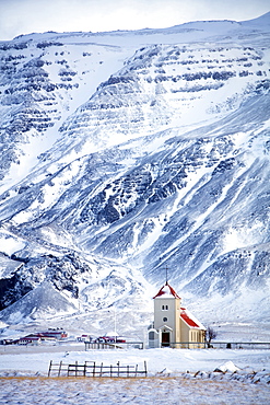 Church and isolated farm against snow covered mountains, winter afternoon on the road to the Snaefellsnes Peninsula, Iceland, Polar Regions