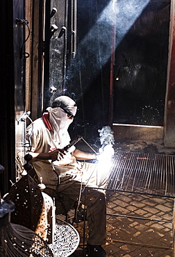 Worker in Blacksmiths Souk welding metal, Marrakech, Morocco, North Africa, Africa