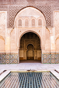 Wall of Ben Youssef Madrasa (ancient Islamic college) with reflection in pool of water, UNESCO World Heritage Site, Marrakech, Morocco, North Africa, Africa