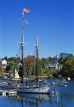 Traditional boat flying the Stars & Stripes, moored in the harbour at Rockport, Maine, New England, United States of America, North America