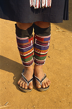 Close-up of legs and feet of a person of the Akha hill tribe wearing colourful cloth leg coverings, at Doitung, Chiang Rai, Golden Triangle, Thailand, Southeast Asia, Asia