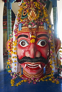 Close-up of statue with wide eyes and fangs at Sri Mariamman temple, a Hindu temple on Pagoda Road, Singapore, Southeast Asia, Asia