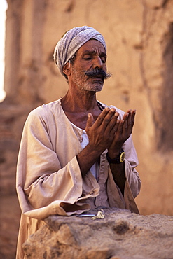 Man praying, St. Simeon monastery, Aswan, Egypt, North Africa, Africa