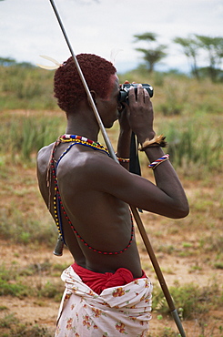 Samburu Moran (warrior) using binoculars, Kenya, East Africa, Africa