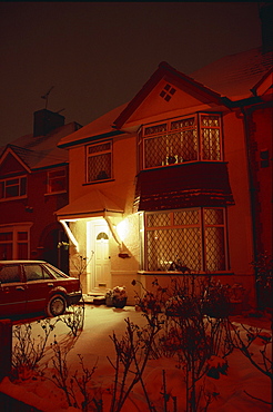 A house in the Crossways at night with snow on the ground, in Heston, Middlesex, England, United Kingdom, Europe