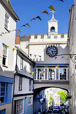 Town clock embedded in a bridge over the High Street in Totnes, Devon, England, United Kingdom, Europe