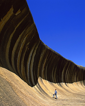 A man gazing up at Wave Rock, at Hyden, Western Australia, Australia, Pacific