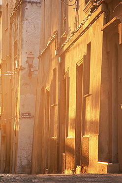 Evening sunlight illuminates a wall in the old town, Bonifacio, Corsica, France, Europe