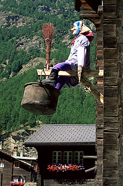 Witch hanging outside village house, Tasch, near Zermatt, Valais, Switzerland, Europe