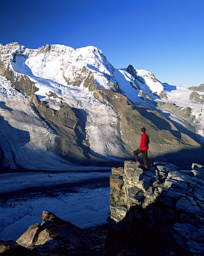 Hiker and view to the Breithorn and Breithorn Glacier, Gomergrat, Zermatt, Valais, Switzerland, Europe