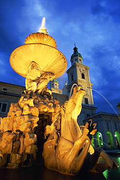 The 17th century fountain in the Residenzplatz illuminated by night, Salzburg, Austria, Europe