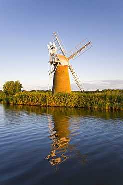 Turf Fen windmill reflected in the River Ant at sunrise, Norfolk Broads, How Hill, near Ludham, Norfolk, England, United Kingdom, Europe