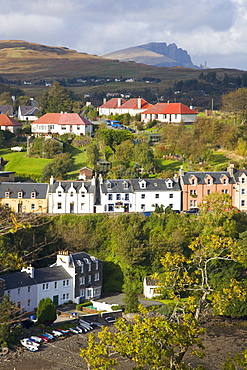 Houses on hillside overlooking the harbour, the Storr visible on horizon, Portree, Isle of Skye, Highland, Scotland, United Kingdom, Europe