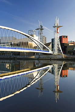 The Millennium Bridge reflected in the Manchester Ship Canal, Salford Quays, Salford, Greater Manchester, England, United Kingdom, Europe