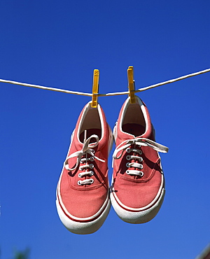 Pair of beach shoes on washing line