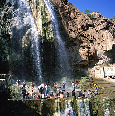 Local people gather at the hot springs and waterfall at Hammamat Ma' In, Jordan, Middle East